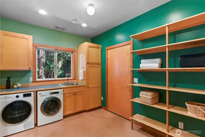 Laundry/mudroom garage access with plenty of storage too.