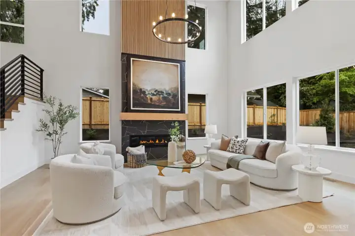 Dramatic two-story fireplace with large-format porcelain tiles, gold veining, and vertical slat panel accents, designed as a statement focal wall.