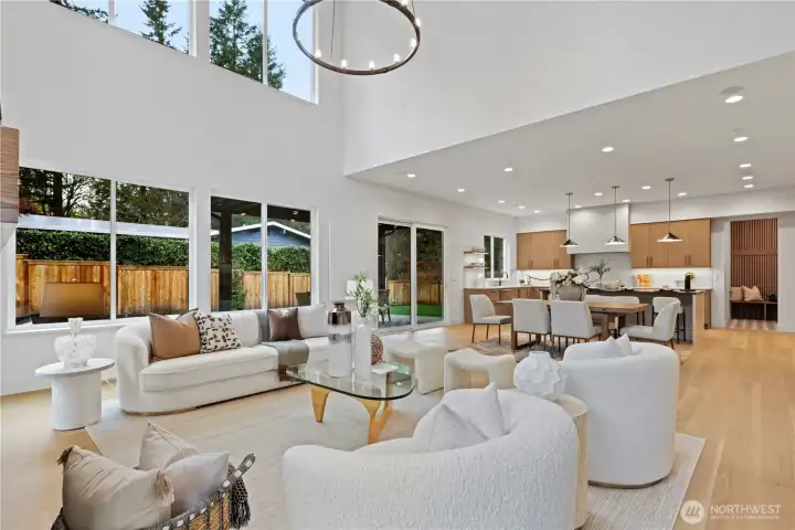 Light-filled great room flows to the kitchen with warm wood cabinetry, oversized island and seamless indoor-outdoor connection.