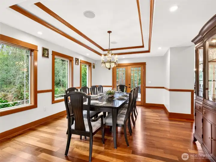 The formal dining room dazzles with a coffered tray ceiling, rich Brazilian cherry hardwoods, and French doors opening to the back deck for seamless indoor-outdoor entertaining. Built to host holidays, dinner parties, and milestone celebrations in true estate style.