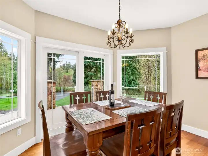 A sun-drenched breakfast nook with bay windows and glass slider access to the back deck makes mornings feel like a retreat. Sip coffee while taking in the verdant, private wooded views just beyond the glass.