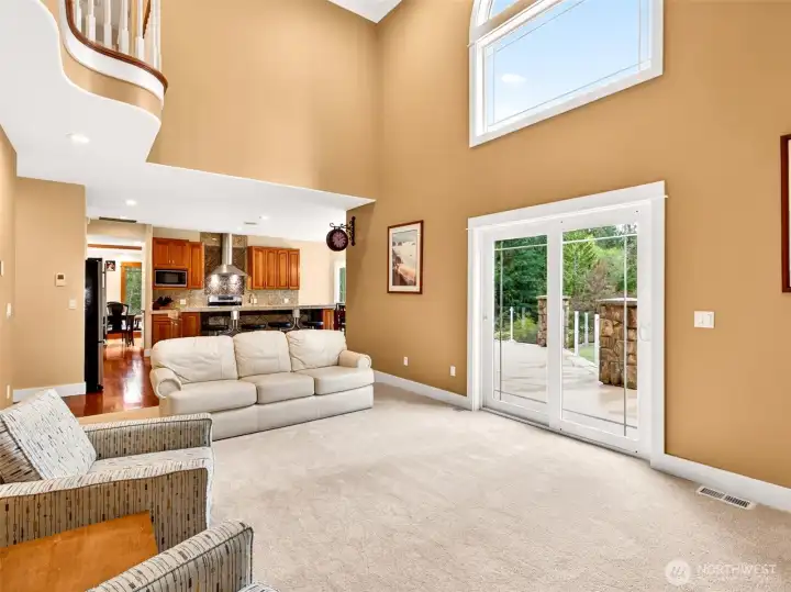 Dramatic 18-foot ceilings, an open balcony overlook with slider door access, as well as an oversized window fill the family room with natural light and a sense of grandeur. Perfectly positioned beside the kitchen for seamless entertaining flow.