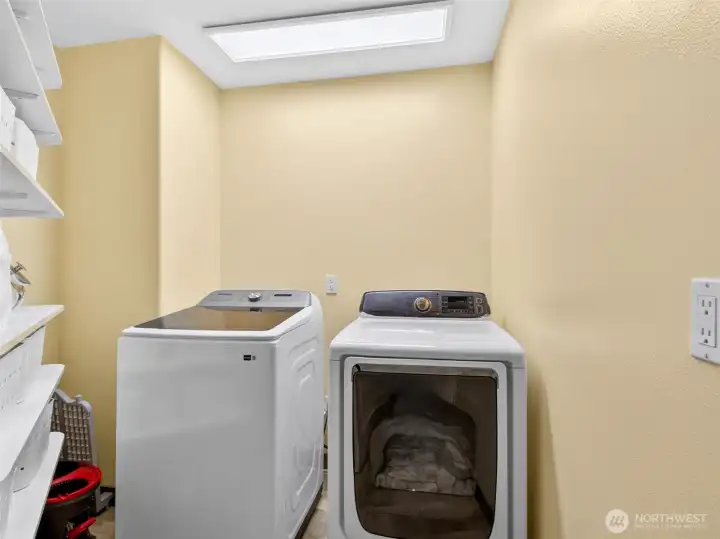 A dedicated upstairs laundry room with skylight keeps daily chores convenient and bright, just steps from the bedrooms. Smart placement that simplifies everyday life.