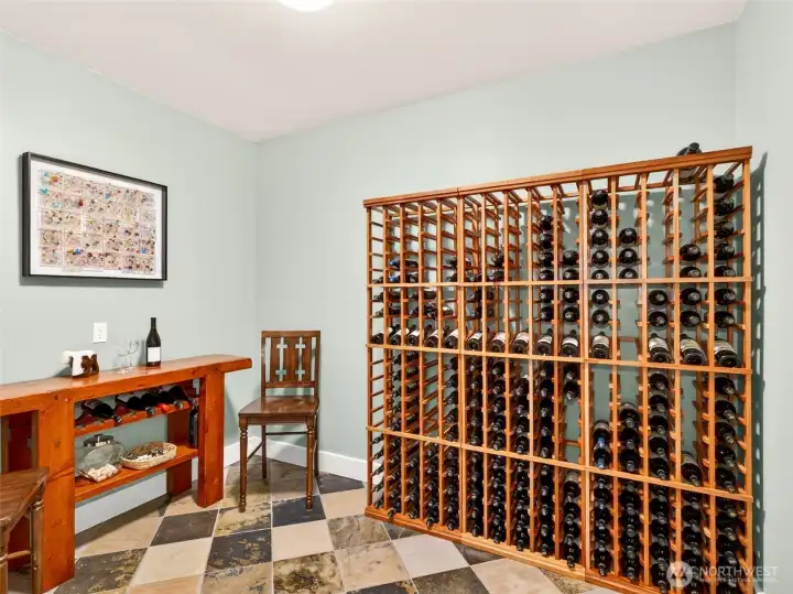 A purpose-built wine room with floor-to-ceiling racking holds hundreds of bottles in style, with thick concrete walls that maintain ideal storage conditions year-round.