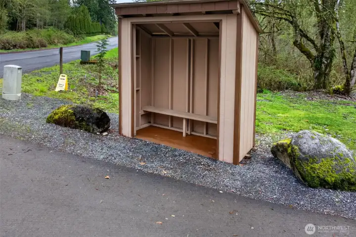A covered bus stop shelter at the street, shared with neighbors, offers a thoughtful touch of community convenience. A small detail that speaks to the friendly, walkable character of the area.