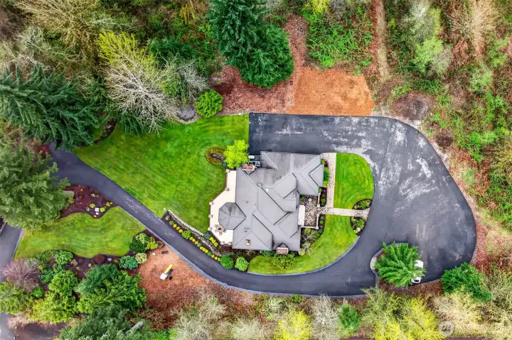 Looking straight down, the home's elegant rooflines, sweeping circular driveway, and meticulously maintained grounds reveal the full scope of this estate property. Every detail thoughtfully placed and beautifully maintained.