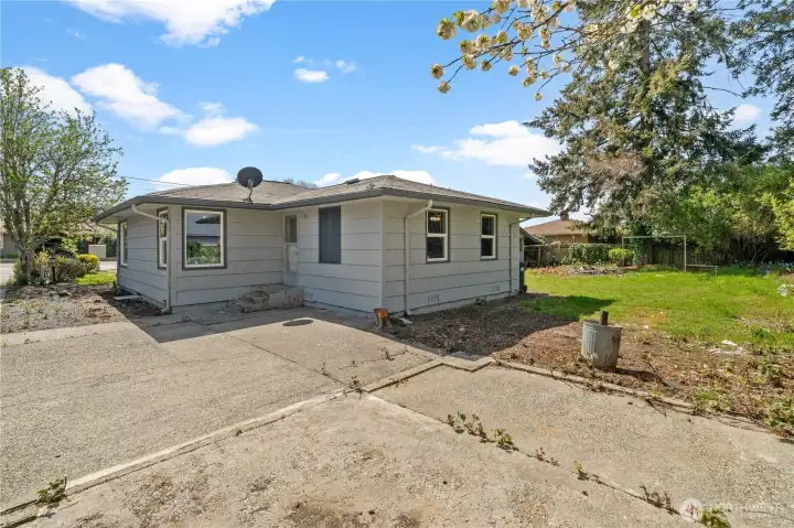 Backyard with driveway and concrete patio    1209 Wheeler St S, Tacoma, WA 98444-3843
