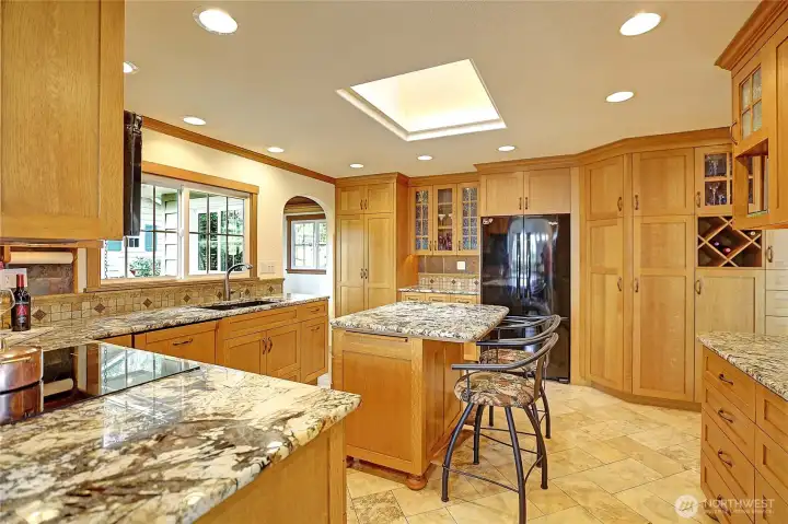 The kitchen detailing and lighting is impressive with custom rollouts and surprises everywhere you look. Granite counters, travertine floors and backsplash. The island countertop is heated. A must-see kitchen!