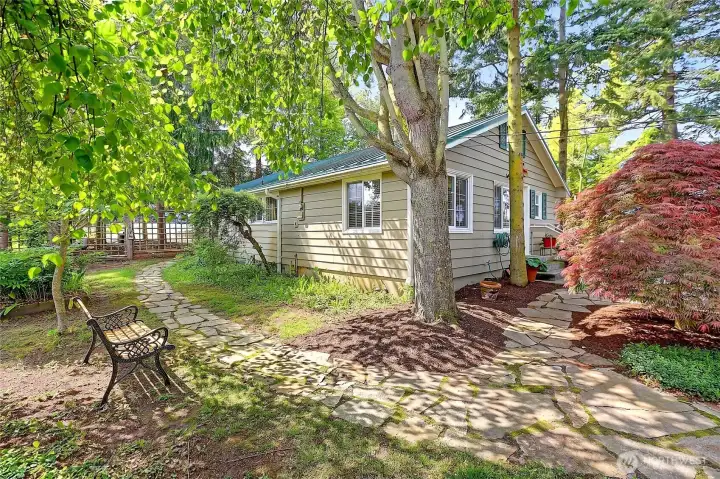 Two car garage and studio apartment building surrounded by Flagstone pathways to and from...