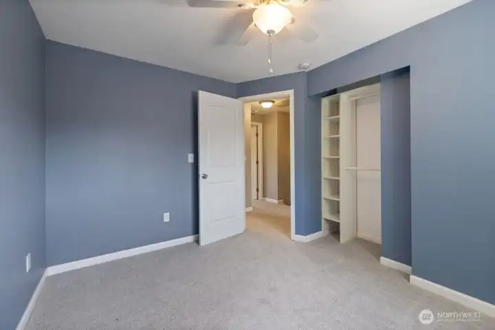 second bedroom adjacent to primary complete with custom closet organization. second bedroom adjacent to primary complete with custom closet organization.