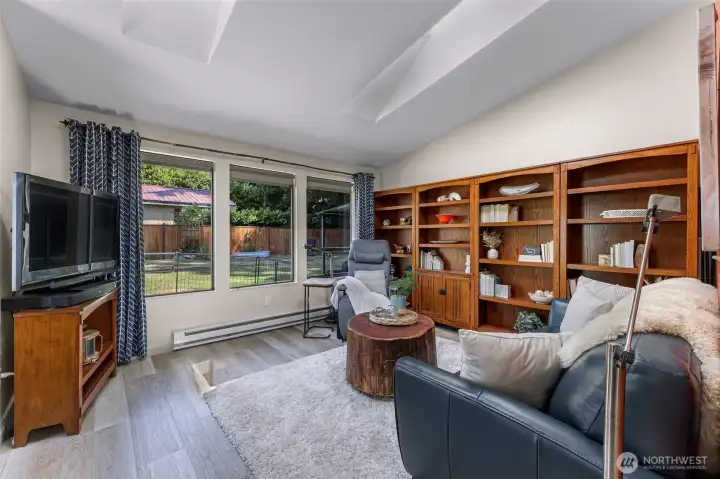 Discover modern living & elegance within this well laid out 900-sf open-concept home featuring vaulted ceilings, skylights, &  beautiful new wide plank LVP floors that successfully create a very spacious feeling