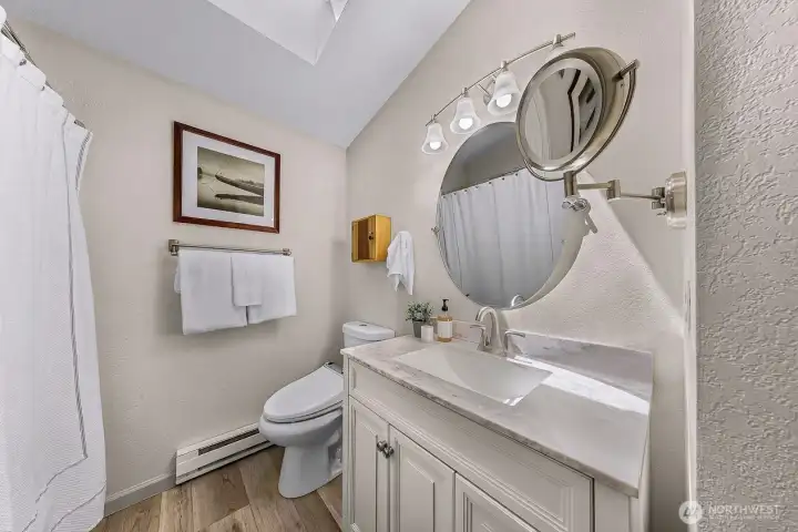 Beautifully updated spa-like full bathroom just steps from both bedrooms