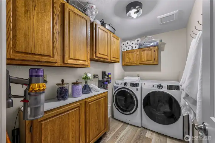 Generous laundry room with full-size Washer and Dryer, plus new cabinetry