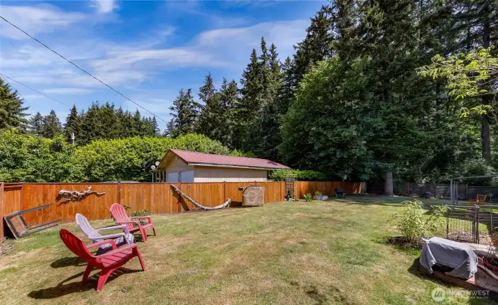 The fenced backyard offers the perfect private retreat with fruit-bearing trees, gardening areas, a chicken coop for your own fresh eggs, & room to play and grow