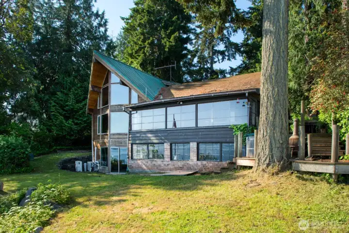 Cedar Home on left adjacent to the original cabin, Main floor door connects the two structures