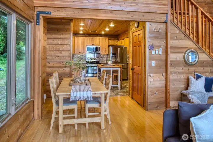 Dining Area into Kitchen with butcher block topped island. Prep your meal while visiting with guests--or a quick cup of coffee on your way out the doo