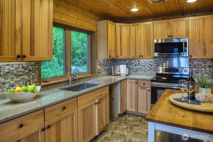 Under cabinet lighting shoes off solid surface countertops and gleaming stainless steel aooliances