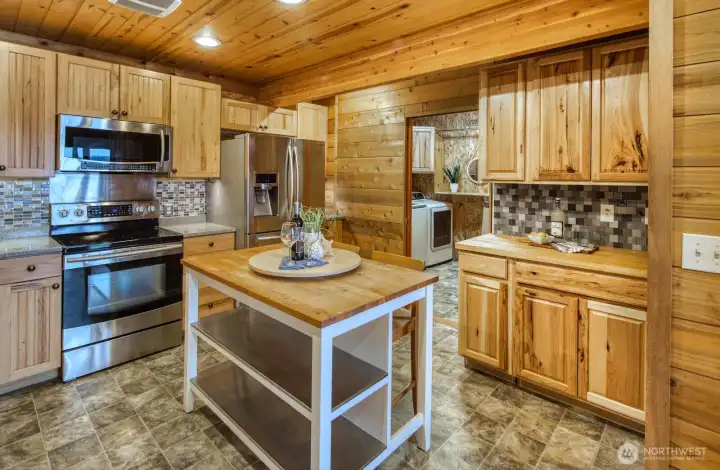 To the right of the island--see into the laundry room. If you don't want to see the laundry, slide the pocket door closed. All appliances convey.