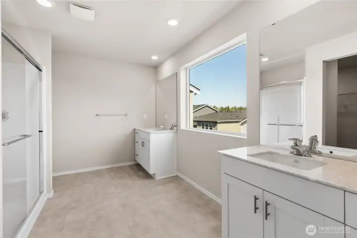 Roomy primary bath with separate vanity and full width mirror. Finishes and options will vary. Roomy primary bath with separate vanity and full width mirror. Finishes and options will vary.