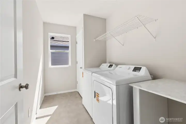 Handy folding table in utility room. Finishes and options will vary. Handy folding table in utility room. Finishes and options will vary.