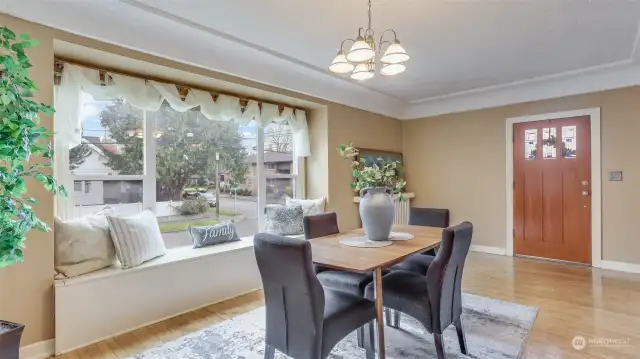 Spacious dining room has a cozy window bench seat located right off the front door.