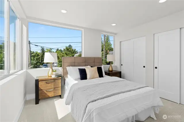 Sunlit additional bedroom with ample closet space and neutral tones to create a calming environment.