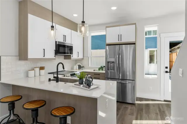 Stylish kitchen with a combination of sleek cabinetry, stainless steel appliances, and quartz countertops.