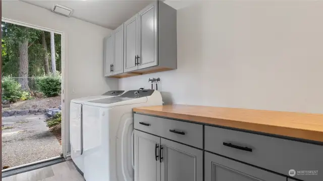 Utility room with newer washer and dryer- exits to garden