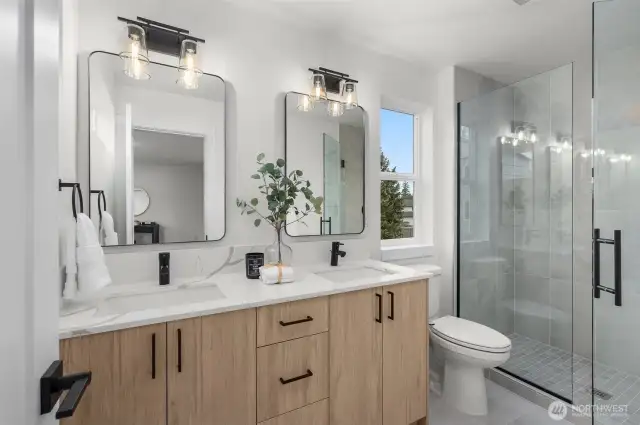 Double the sinks, double the style. This luxe 4-piece bath comes with designer lighting, modern mirrors, matte black finishes, and a large walk-in shower you’ll never want to leave.