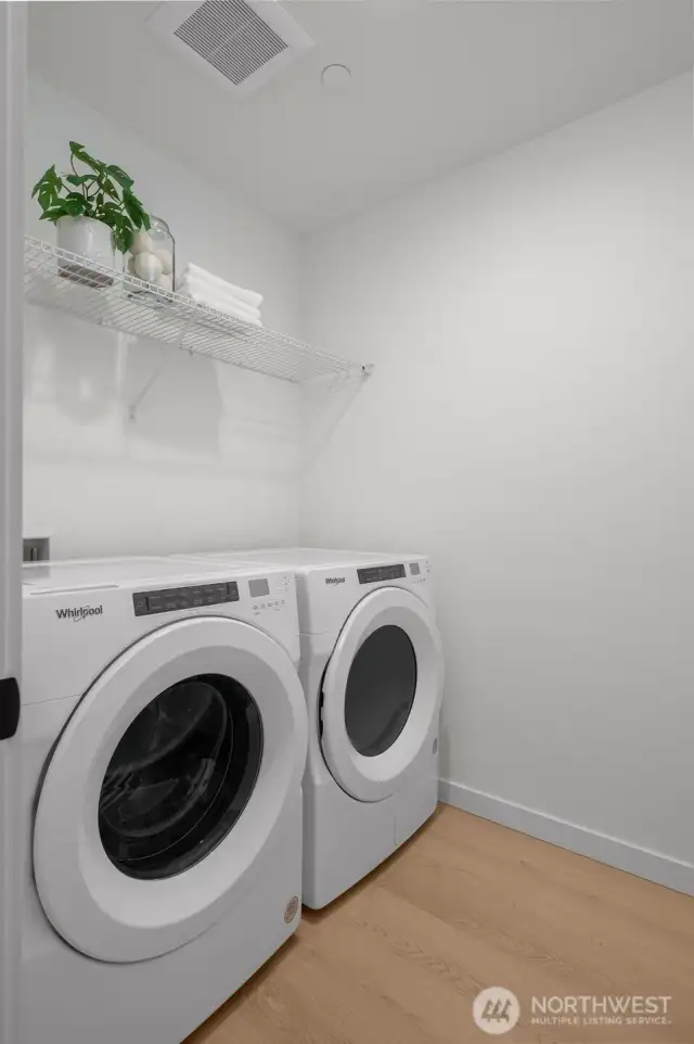 Laundry days just got an upgrade. A clean, tucked-away laundry room with a full-size washer/dryer and extra shelf space to keep things organized and efficient.