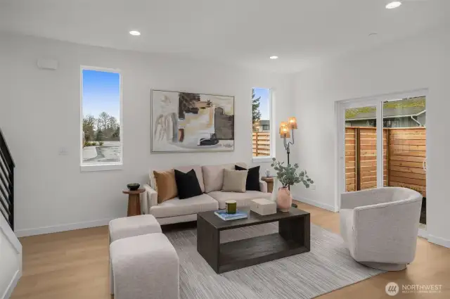 Pull up a chair and stay a while. This inviting living area balances warm wood tones and crisp white walls for an elevated and relaxed vibe—perfect for everything from binge-watching to book club.