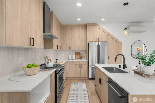 Where design meets function, from the waterfall island to the sleek matte black fixtures, every detail in this kitchen was thoughtfully curated for high-style living.