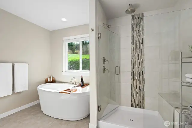 5 piece primary bathroom with soaking tub and access to the walk-in closet.