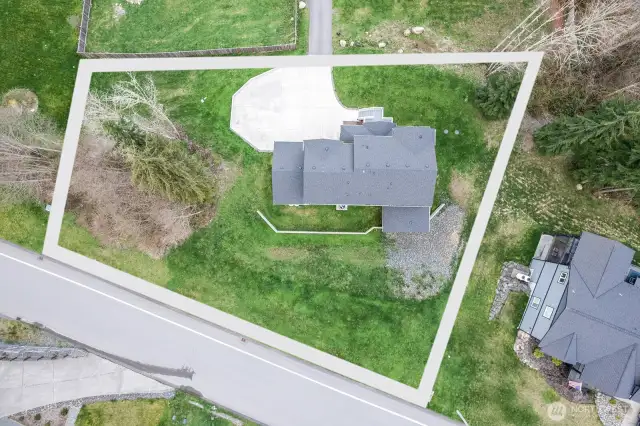 The back of the home faces west off the neighborhood road. The sellers were going to gravel this area for additional parking.