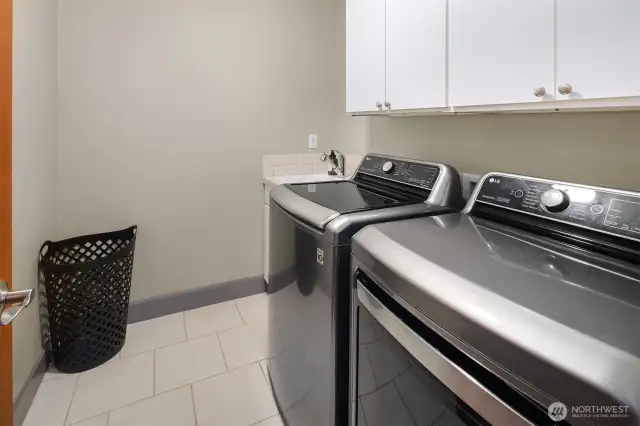 Laundry rooms are a bit of a lost art in today's construction. Not the case here!  This main floor space is conveniently located right inside the garage door.  All kinds of storage and room to operate!  You will appreciate the sweet utility sink.