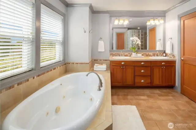 The lavish primary bathroom boasts an oversized jetted tub and plenty of room to share when getting ready in the morning.