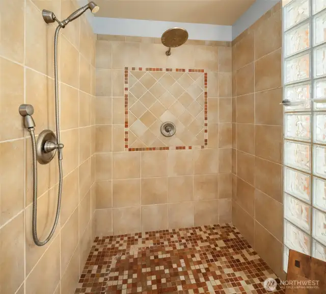 The beautiful glass block shower has full tile surround and is as large as it looks in this picture.
