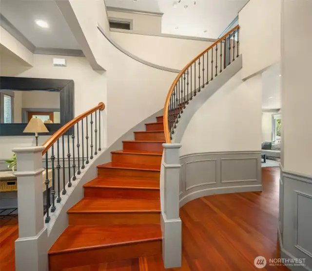 Offset from the entry, this beautiful rounded staircase makes a fabulous first impression.  This home's craftsmanship is several steps ahead of current new construction standards and this beautiful staircase is a great example.  Not just a box of open space, you will love the architectural detail demonstrated throughout this home.  Simply put, they just don't make them like this anymore.