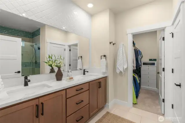 Double sinks w/ walk-in closet attached.