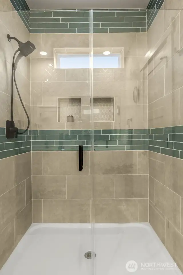Spacious walk-in shower w/ glass door.