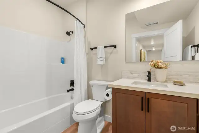 Lower full bathroom in hallway.