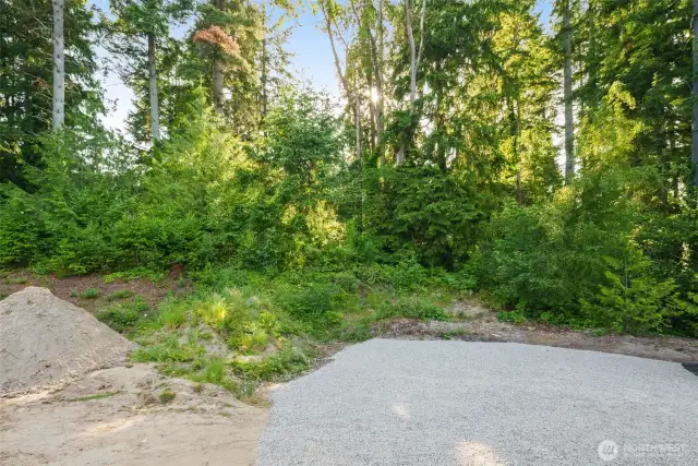 Gravel upper parking area. Dirt on left   will be leveled and ready for lawn/garden.