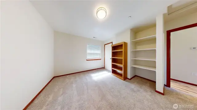 ADU bedroom w/ shelving & closet
