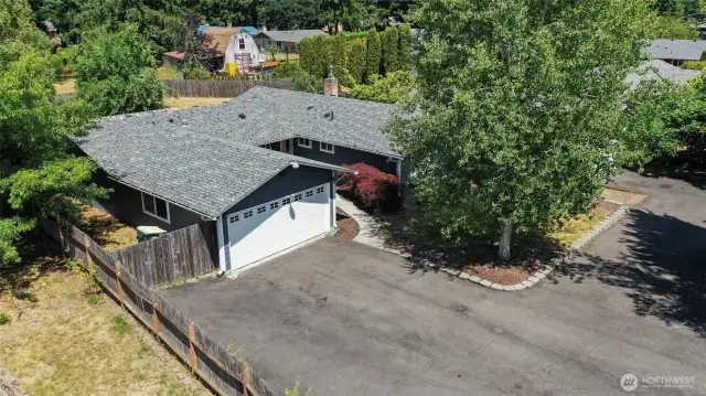 Attached garage seen here, with entry being inside the appealing alcove in the middle.  Plenty of parking and 30Amp RV hookup!