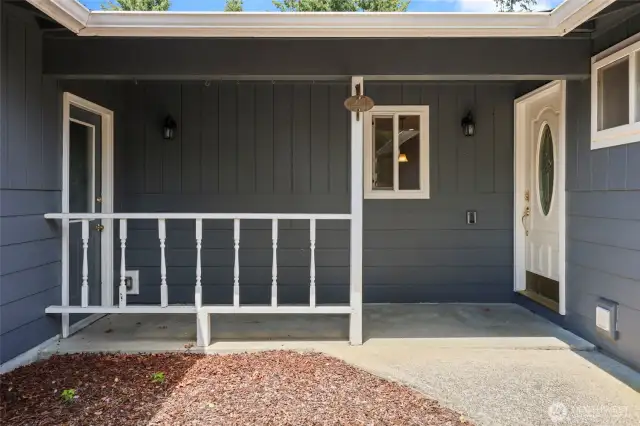 Covered porch connects the home to the attached garage, and makes for an appealing welcome.