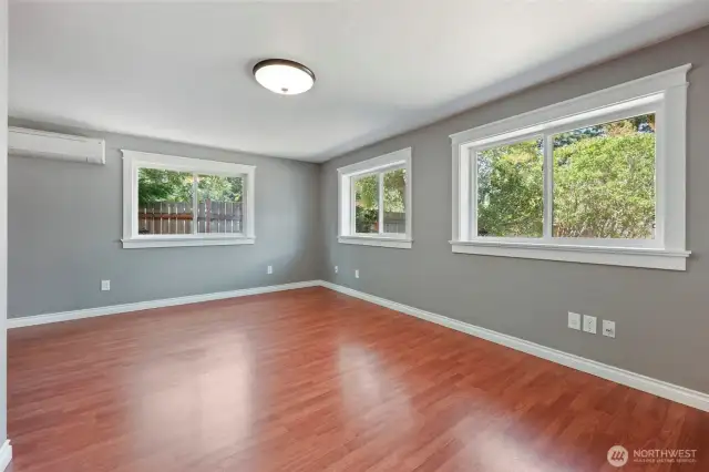 Lots of natural light with three windows looking out to greenery, and dedicated ductless for personal comfort in this primary bedroom.