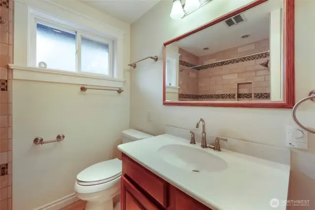 Hallway bath is a full, with tiled shower/tub combo and opening privacy window for great light and extra ventilation. Heated tile floors here, too!