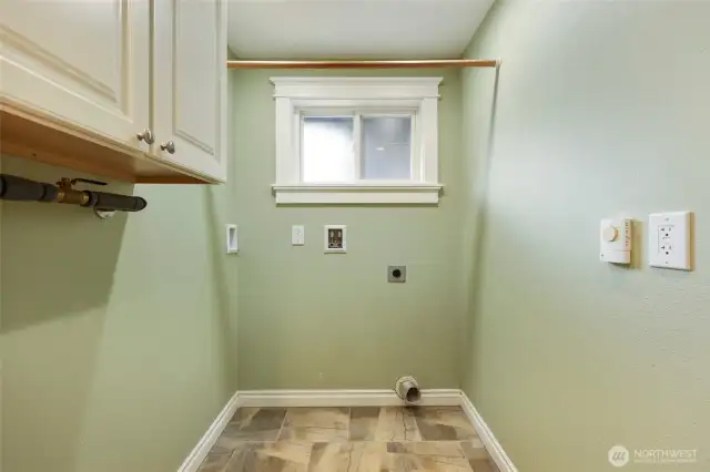 Dedicated utility room (no pass-through!) just off main living area, near kitchen/bedrooms.  Storage cabinet, opening window, tile floor.