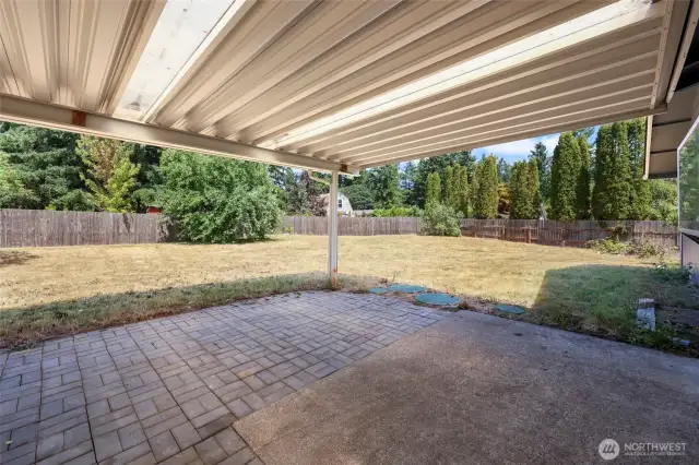 Extended patio off kitchen slider has great cover for all-year enjoyment, which lets in natural light as well.