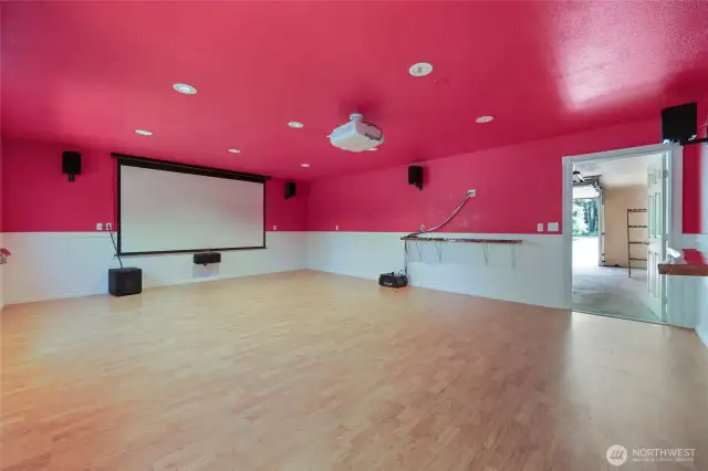 Bonus room behind detached garage is approx 400 square feet, has recessed lights, surround sound, receiver, projector, and screen for amazing movie/game nights!  (color is red, not pink...) ;)